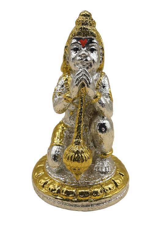 Small statue of a deity in silver and gold on a white background