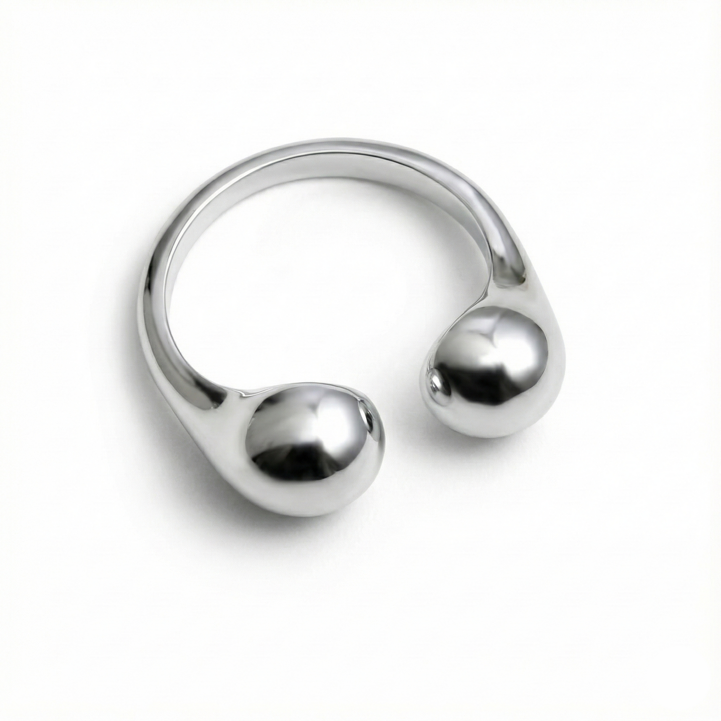 Silver ring with spherical ends on a white background