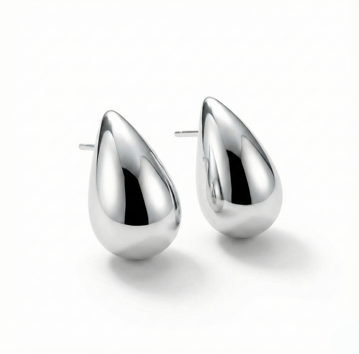 Pair of silver teardrop earrings on a white background