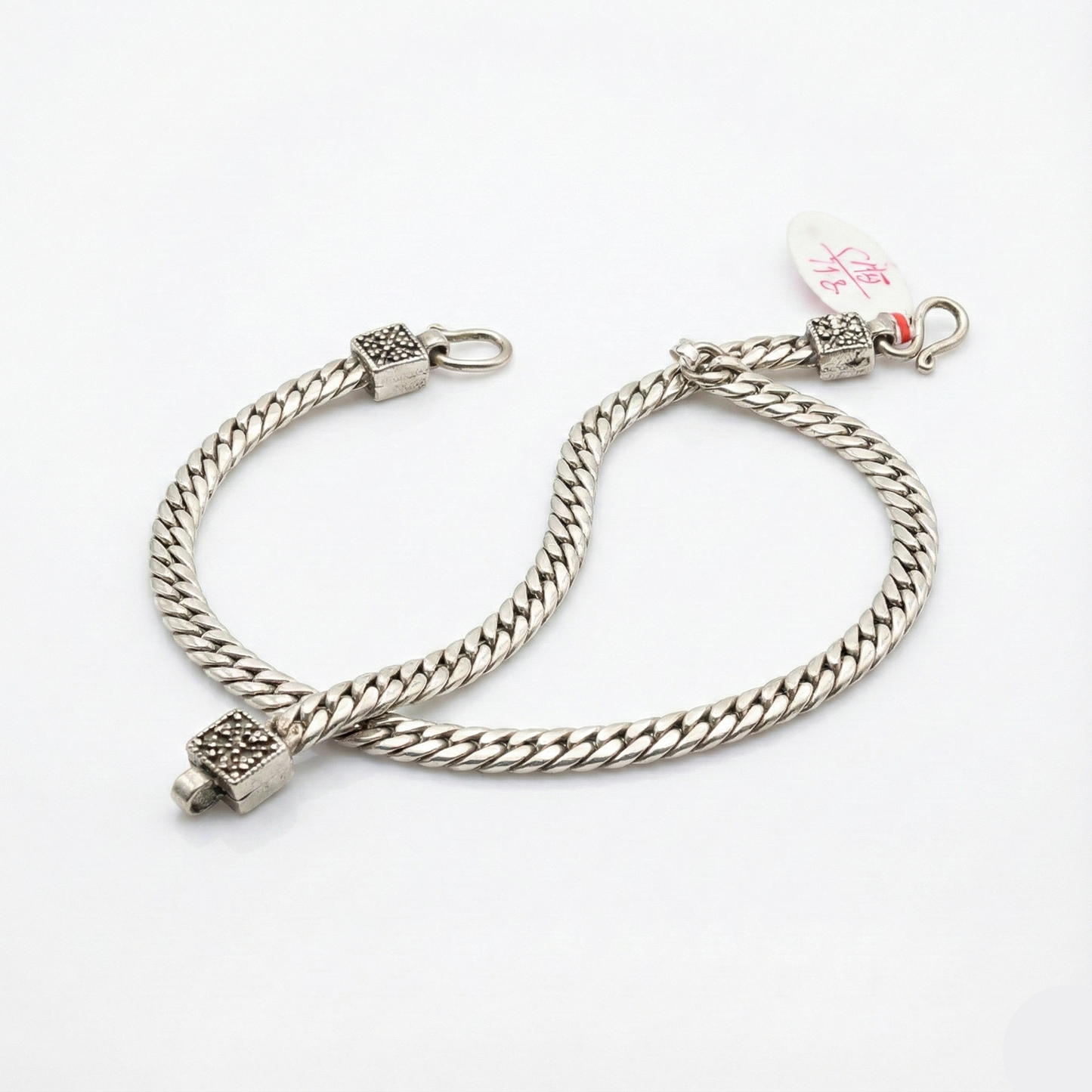 Silver chain bracelet on a white background