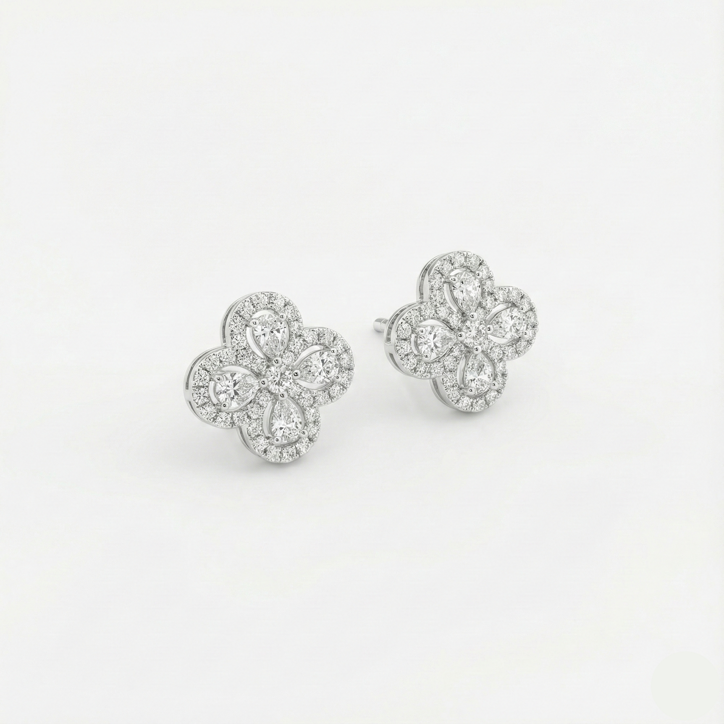 Pair of diamond earrings on a light gray background