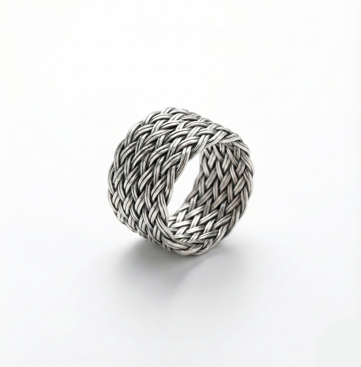 Silver braided ring on a white background