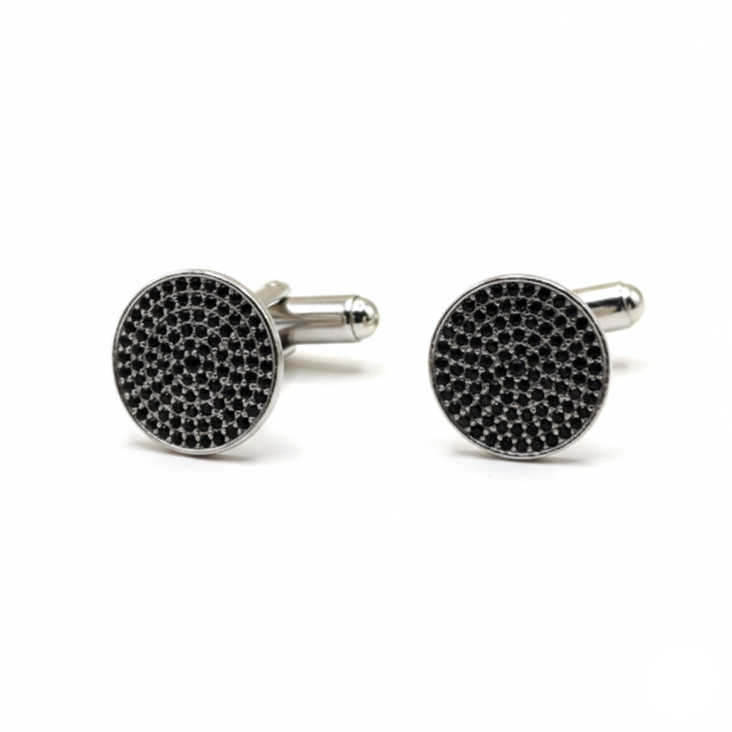 Round cufflinks with black gemstones on a white background