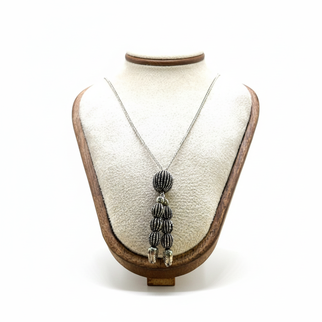 Necklace with a pendant on a mannequin bust against a white background