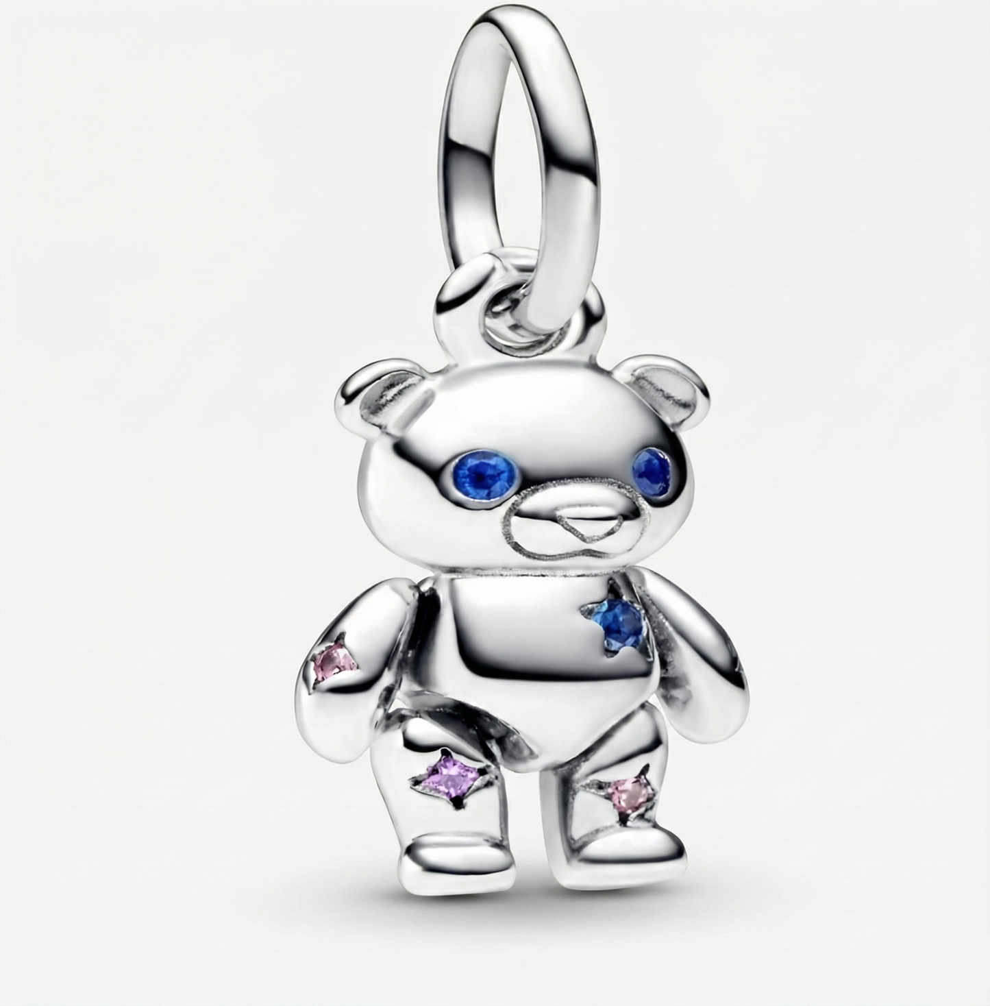 Silver teddy bear charm with colorful stones on a white background