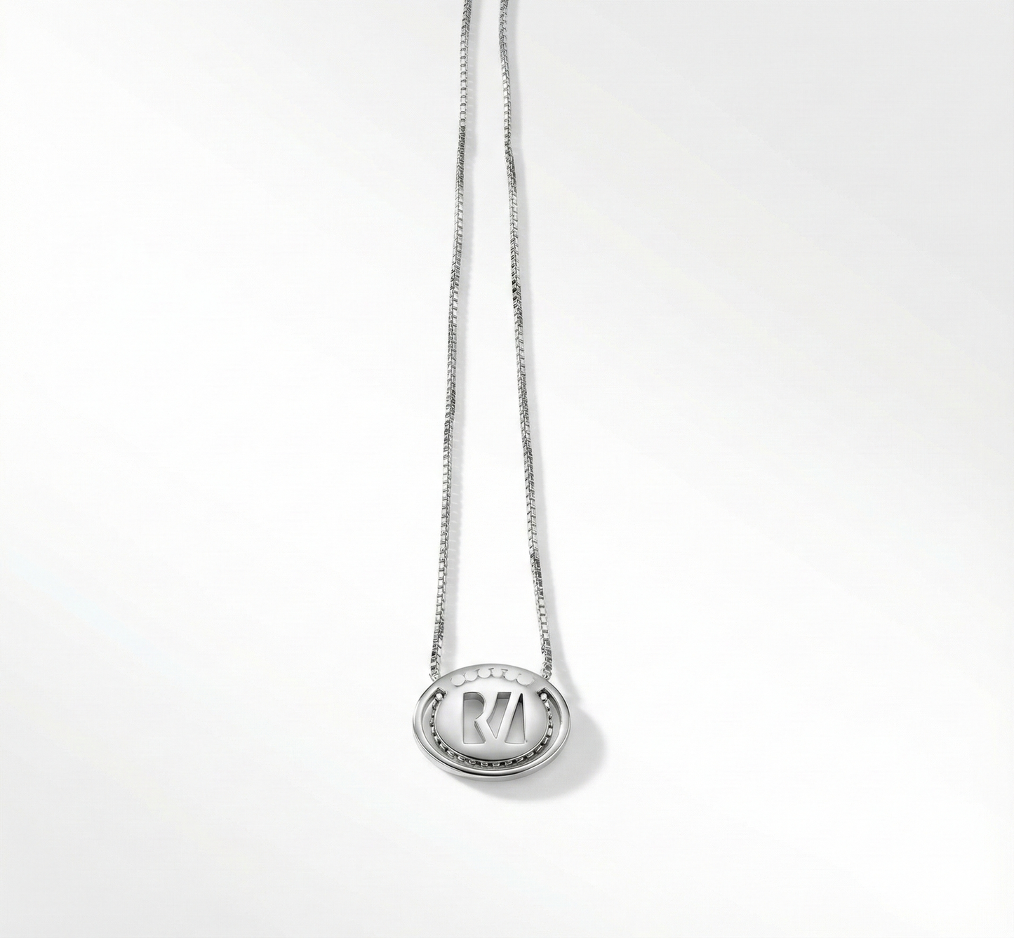 Silver necklace with a pendant on a white background