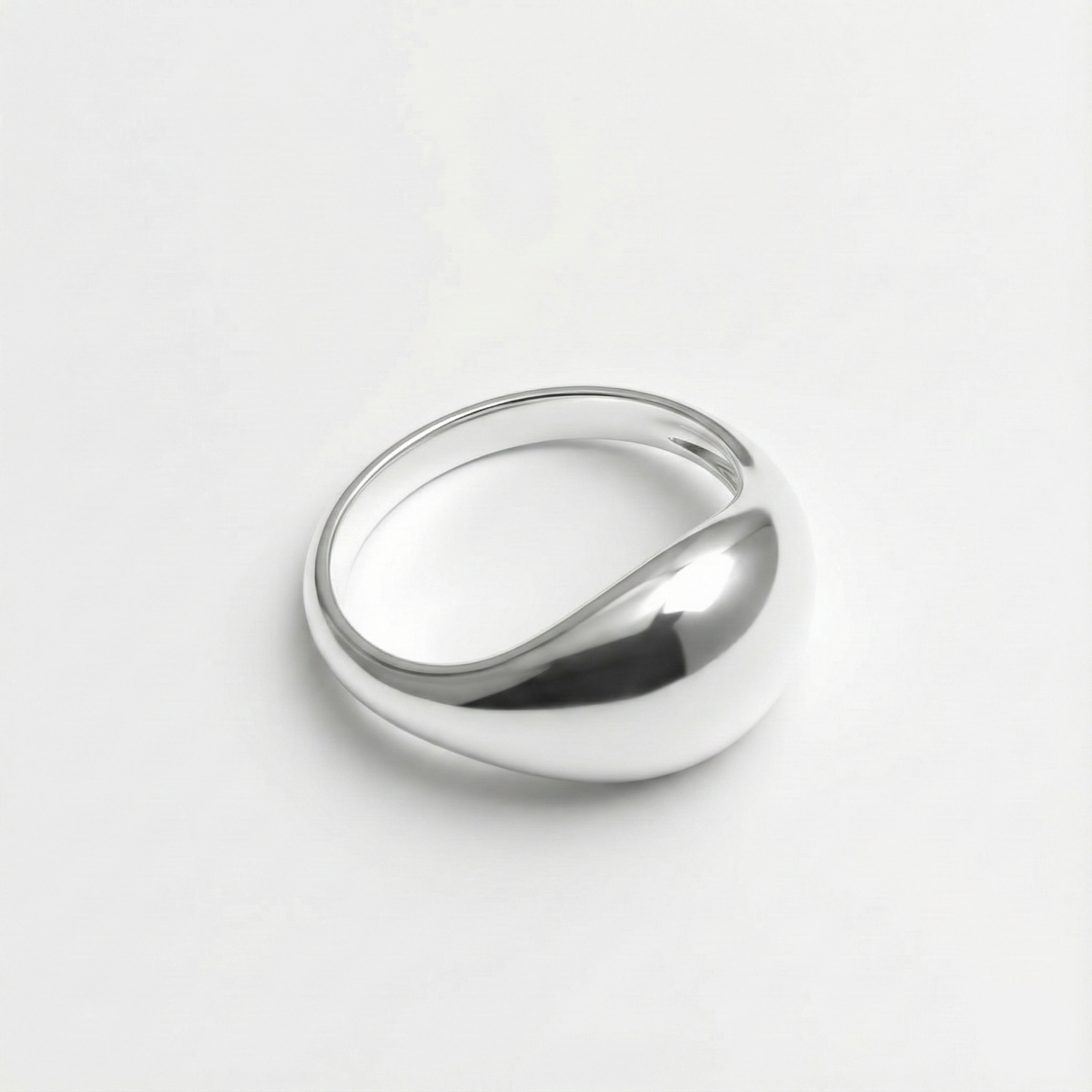 Silver ring on a light gray background
