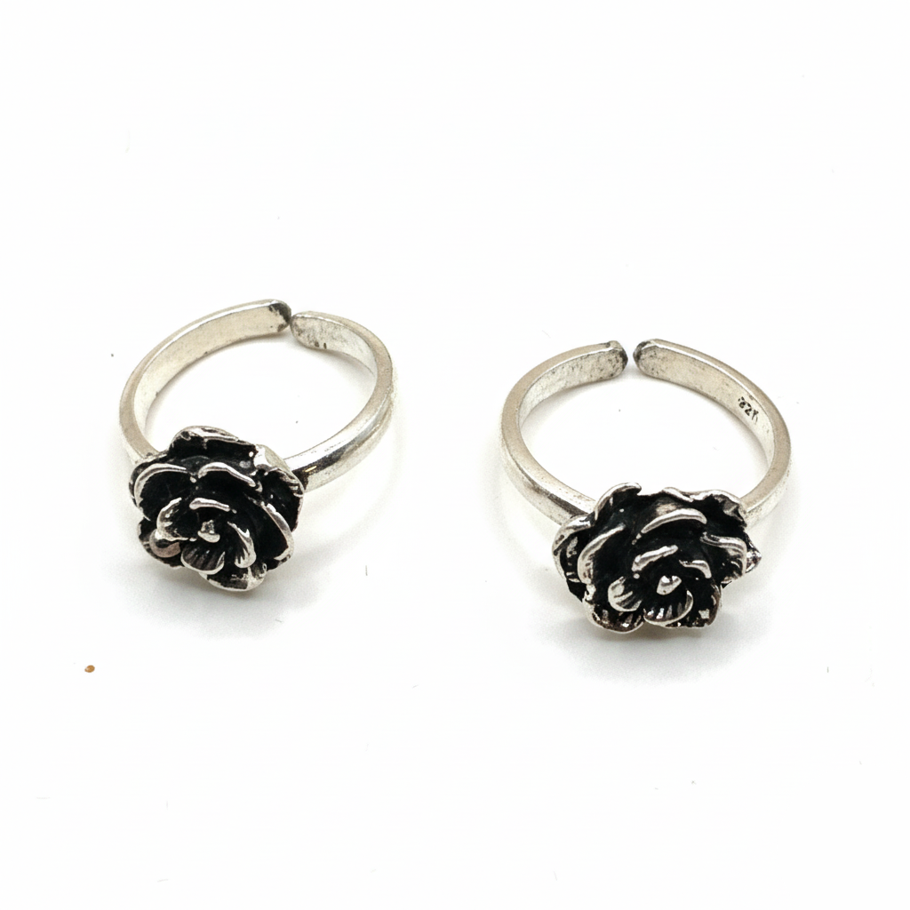 Pair of silver hoop earrings with black rose designs on a white background