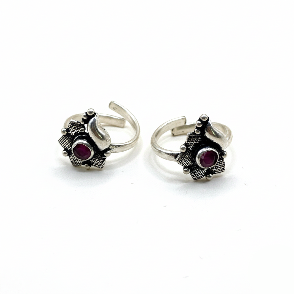 Pair of silver rings with gemstones on a white background