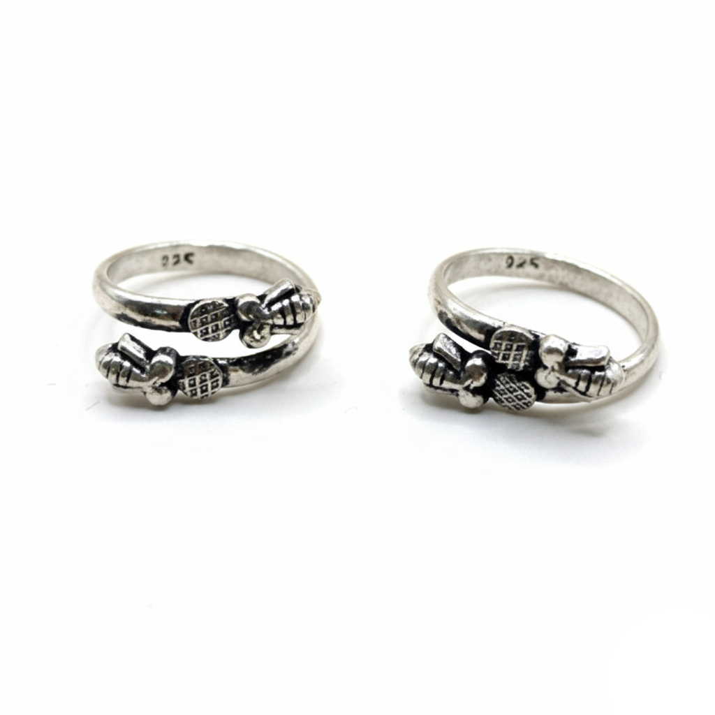 Two silver rings with bow designs on a white background