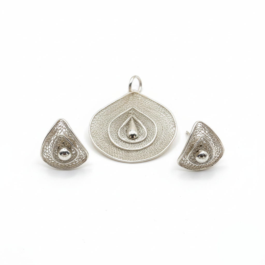 Silver jewelry set with pendant and earrings on a white background