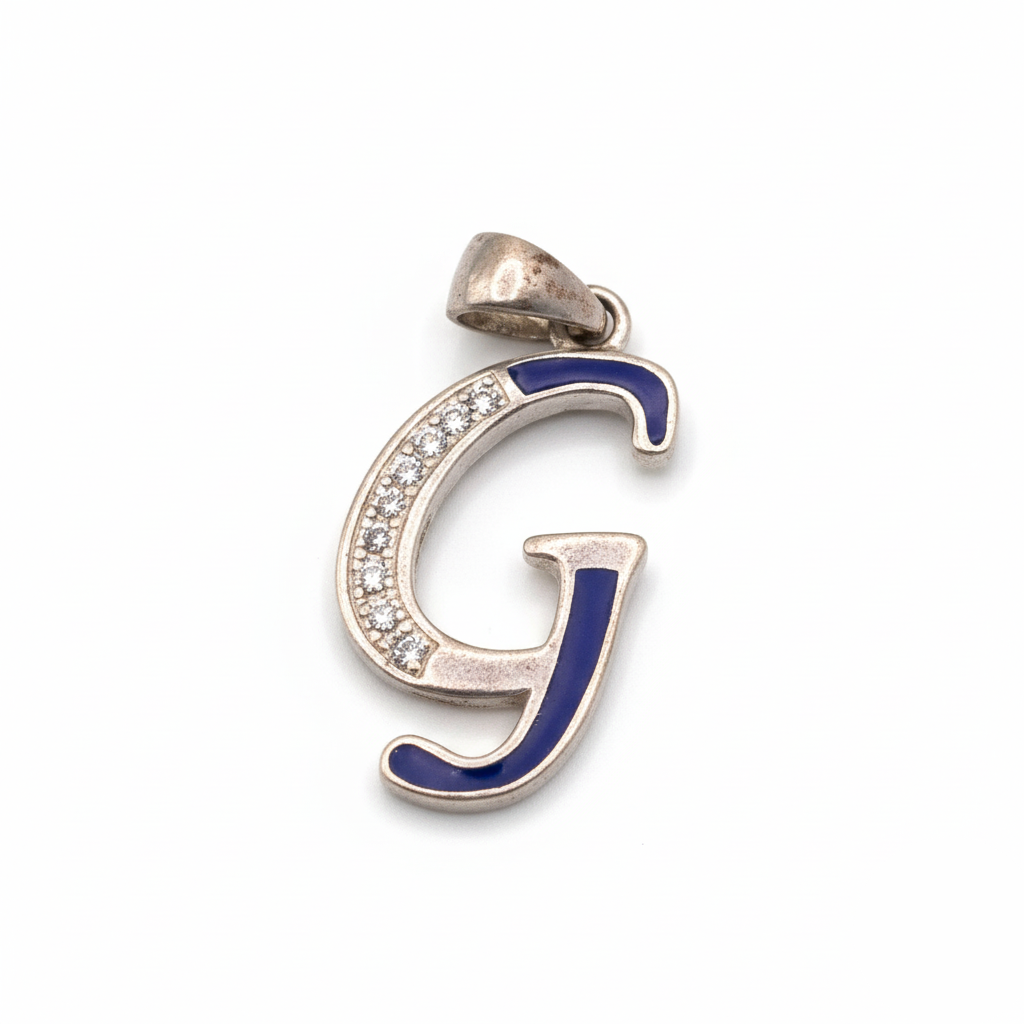 Silver pendant with blue and clear gemstones on a white background