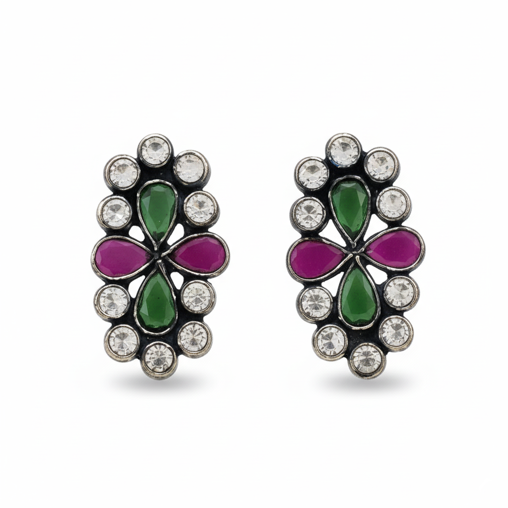 Pair of earrings with green and purple floral designs on a white background