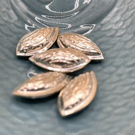 Silver seeds on a textured gray surface