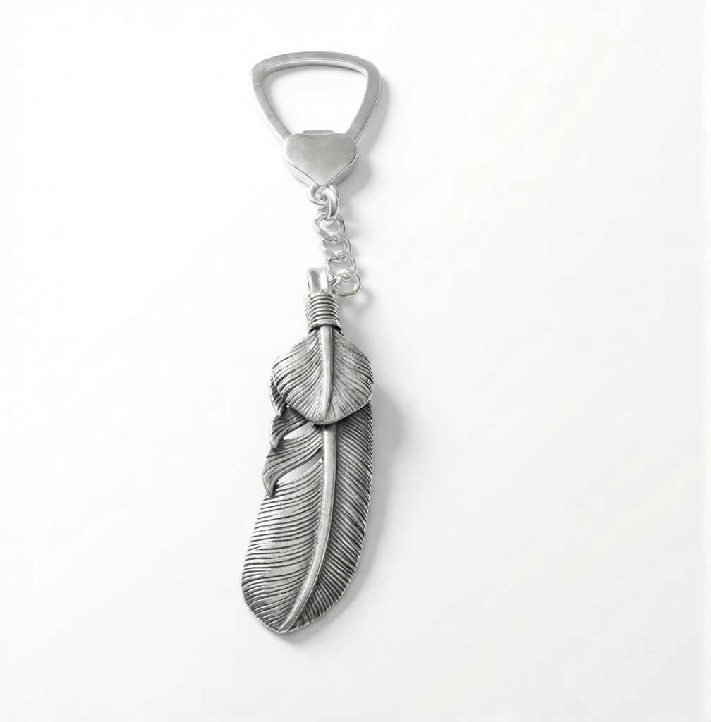 Silver feather-shaped bottle opener on a white background