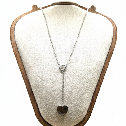 Necklace with a heart pendant on a white display stand