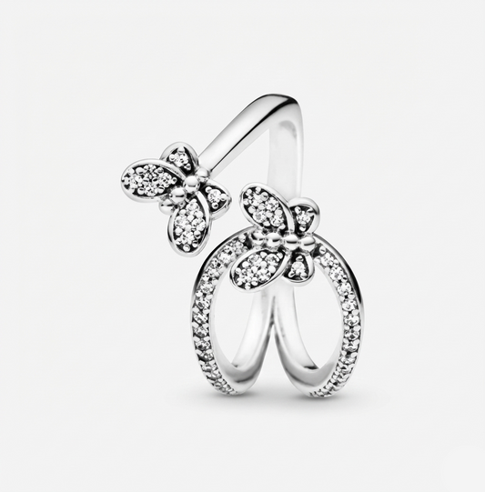 Silver butterfly ring with clear gemstones on a light gray background