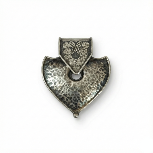 Silver pendant with a textured design on a white background