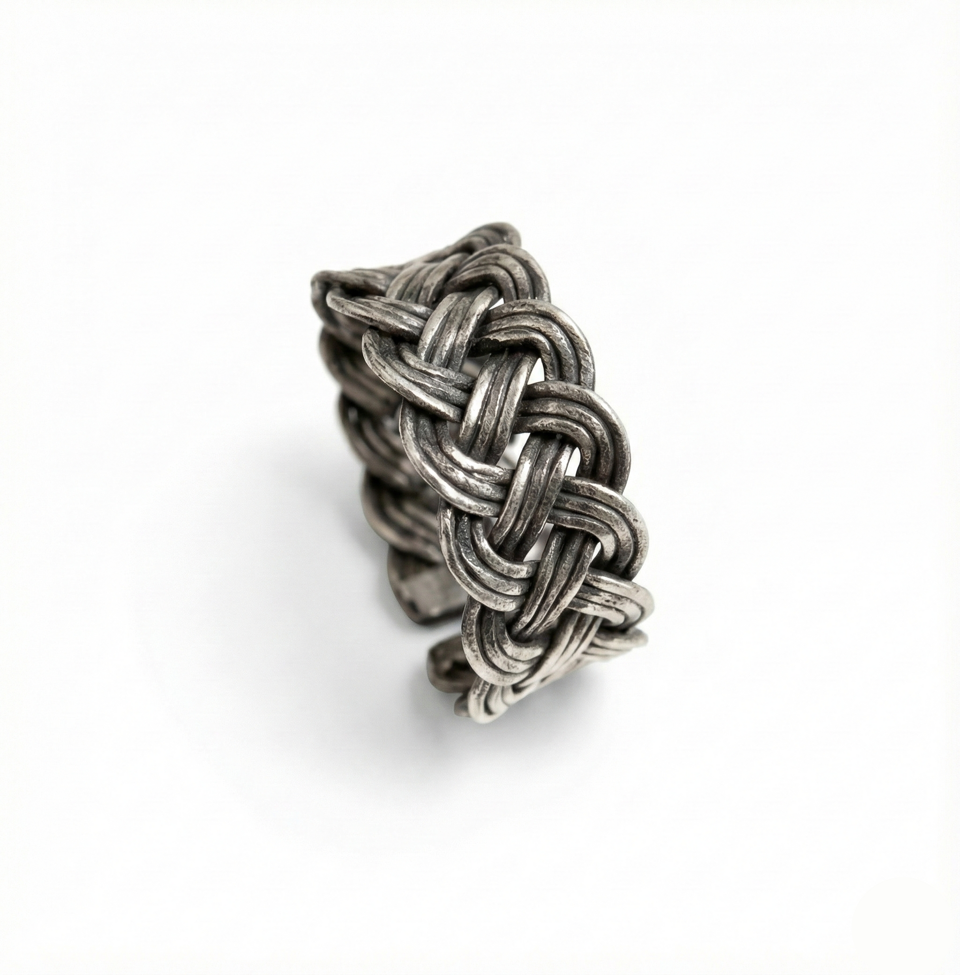 Silver woven ring on a white background