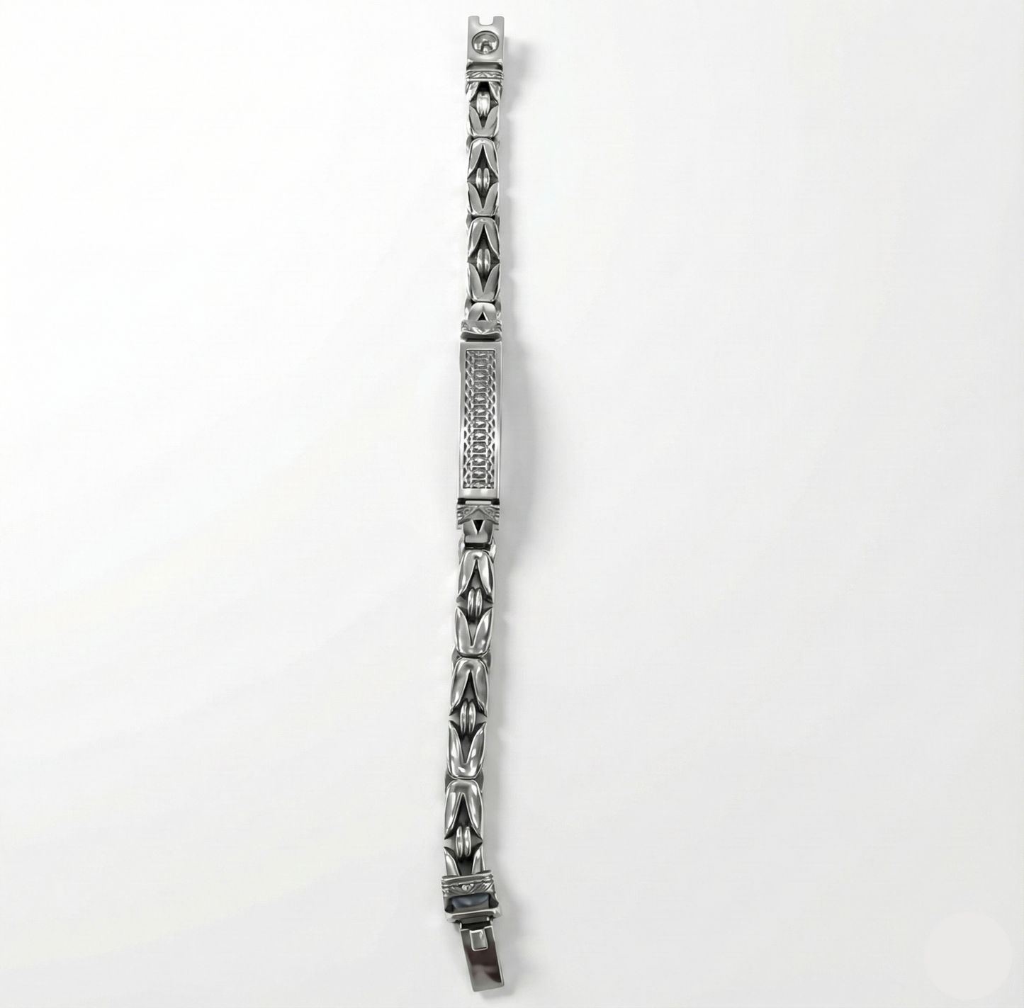 Silver bracelet with intricate design on a white background