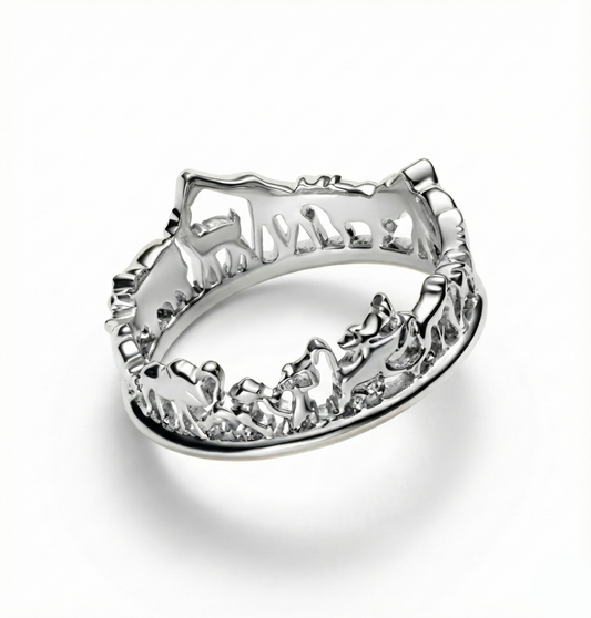 Silver ring with intricate design on a white background