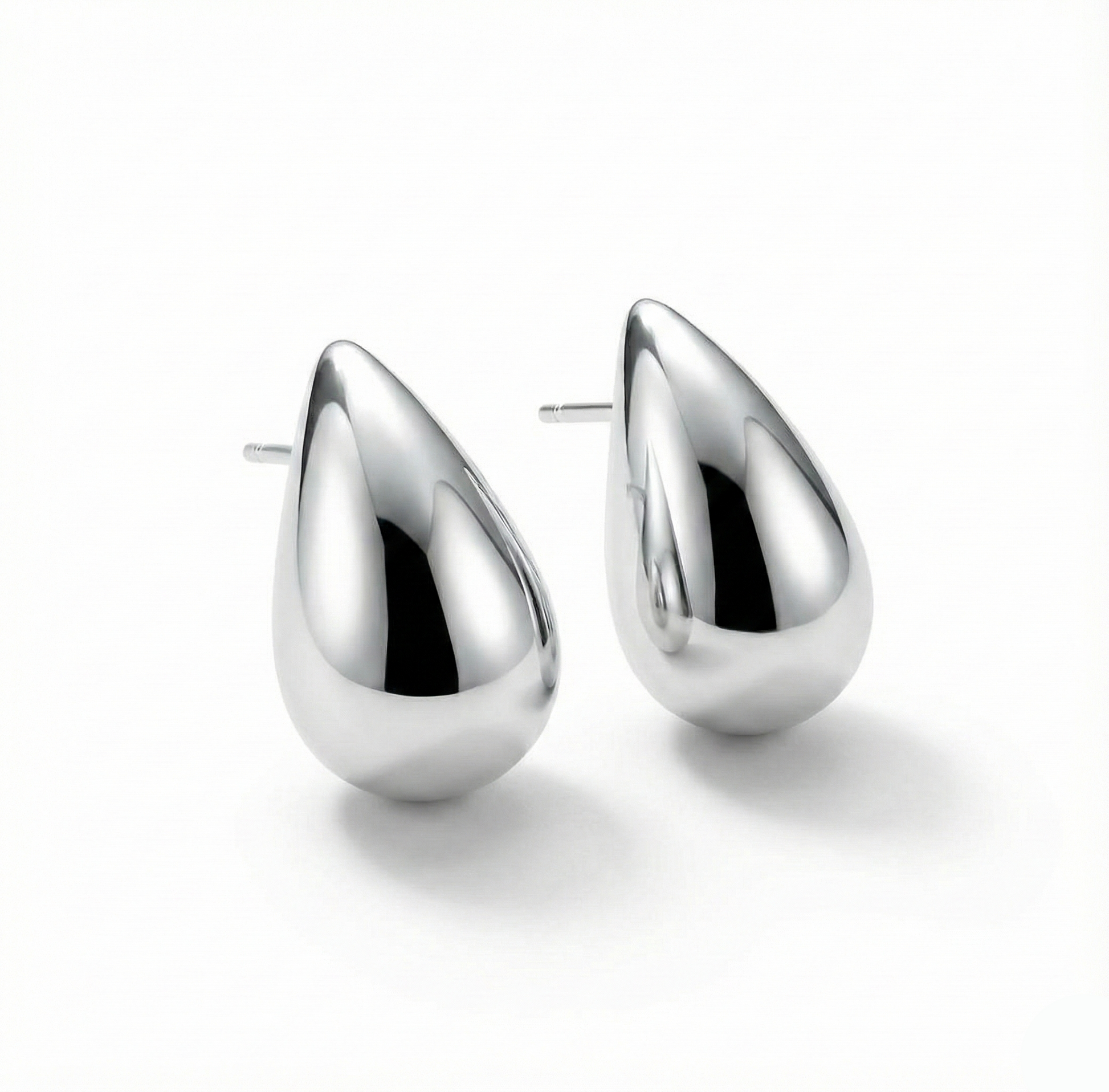 Pair of silver teardrop earrings on a white background