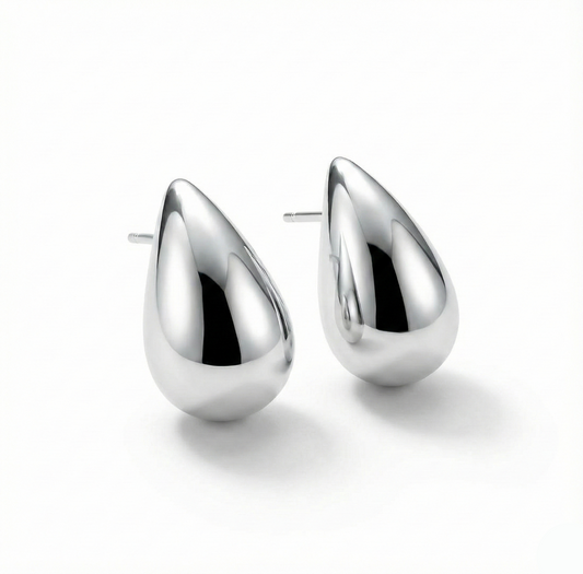 Pair of silver teardrop earrings on a white background