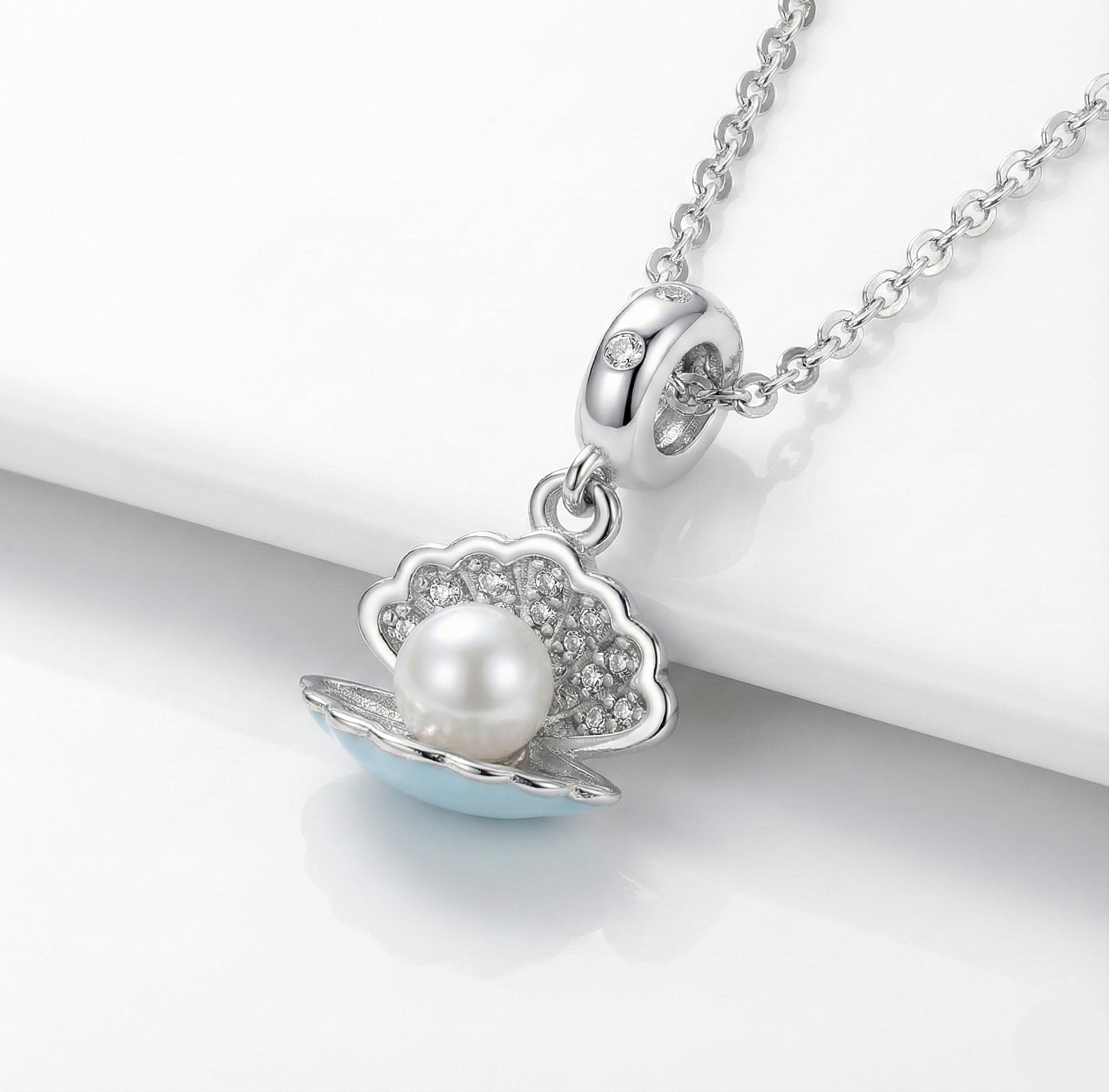 Silver necklace with a pearl pendant on a white background