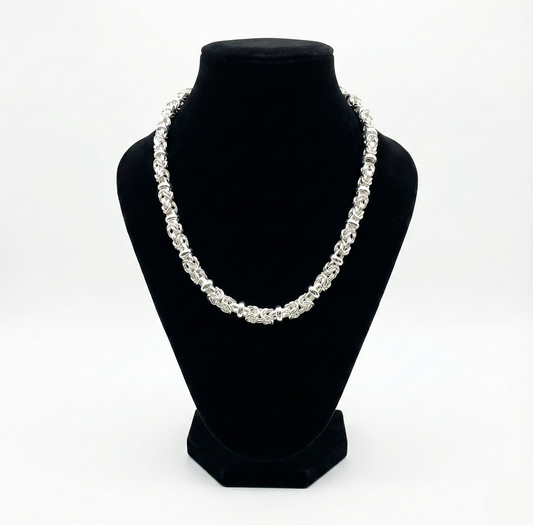 Pearl necklace on a black bust against a white background