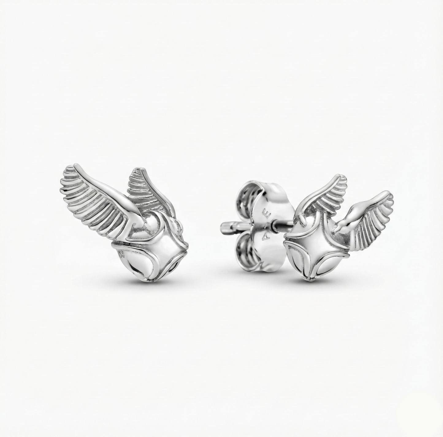 Silver winged earring on a white background