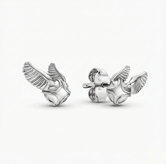 Silver winged earring on a white background