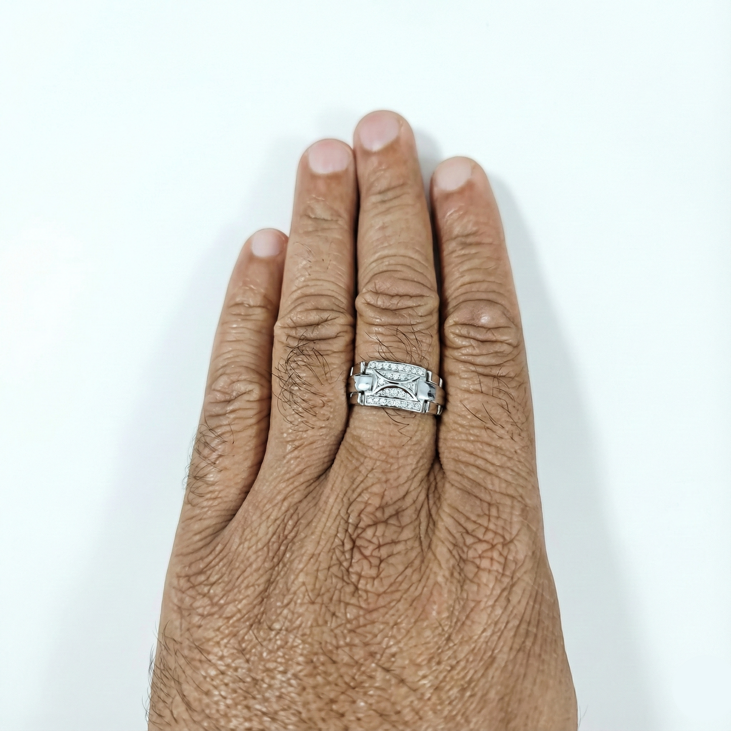 Silver ring on a person's finger against a white background