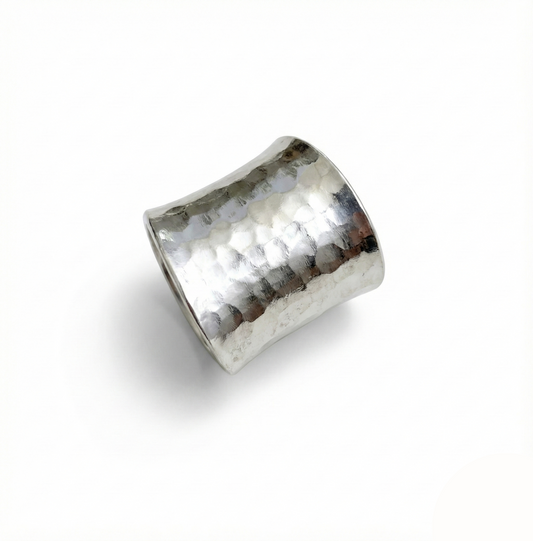 Silver ring with a textured surface on a white background