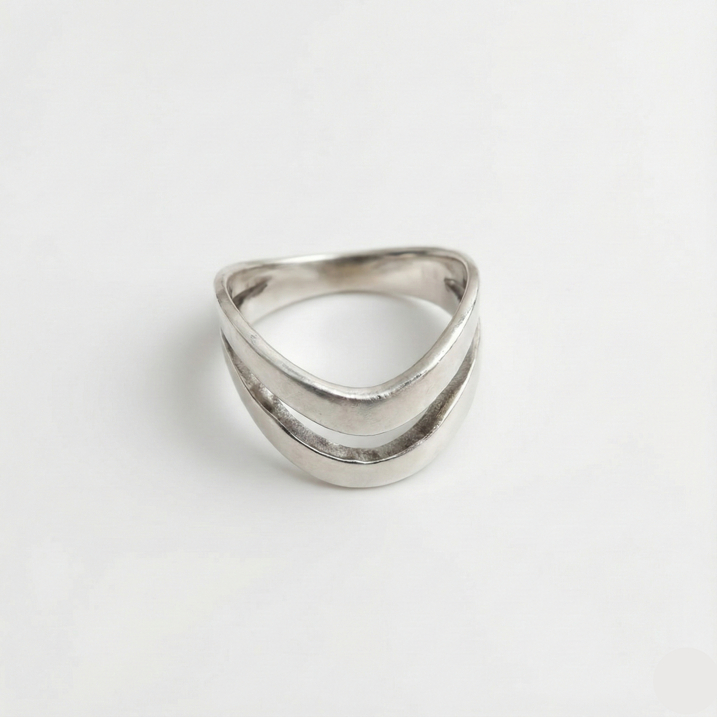 Silver ring with a geometric design on a white background