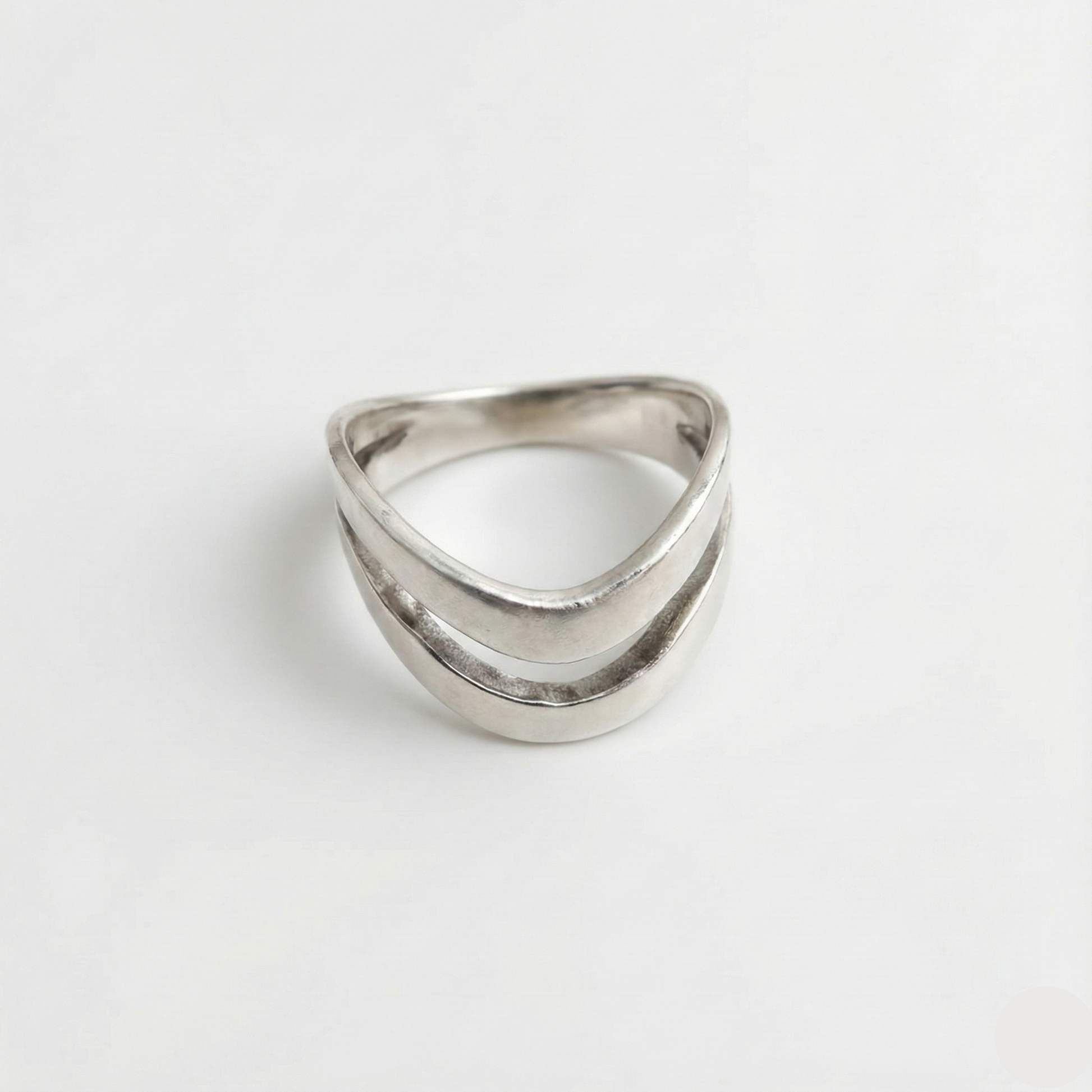 Silver ring with a geometric design on a white background