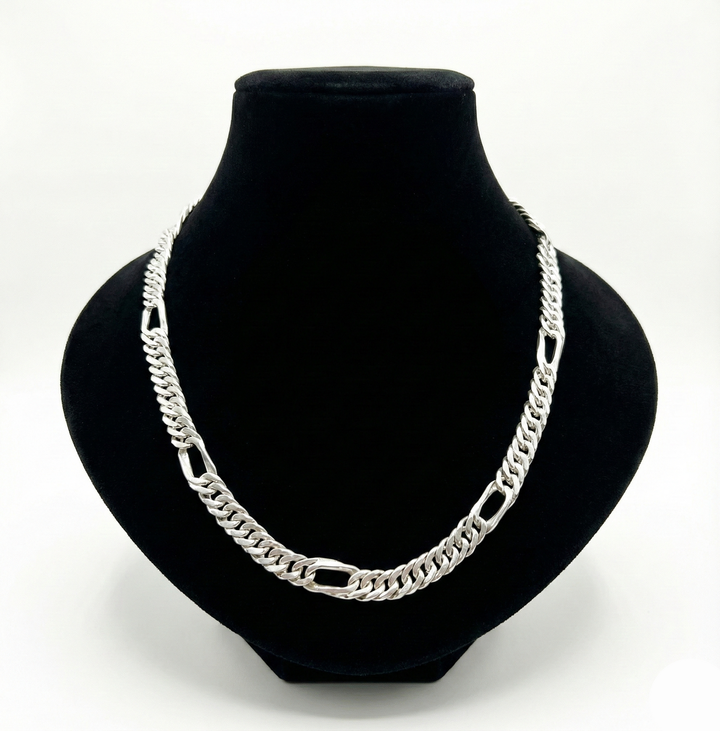 Silver chain necklace on a black bust