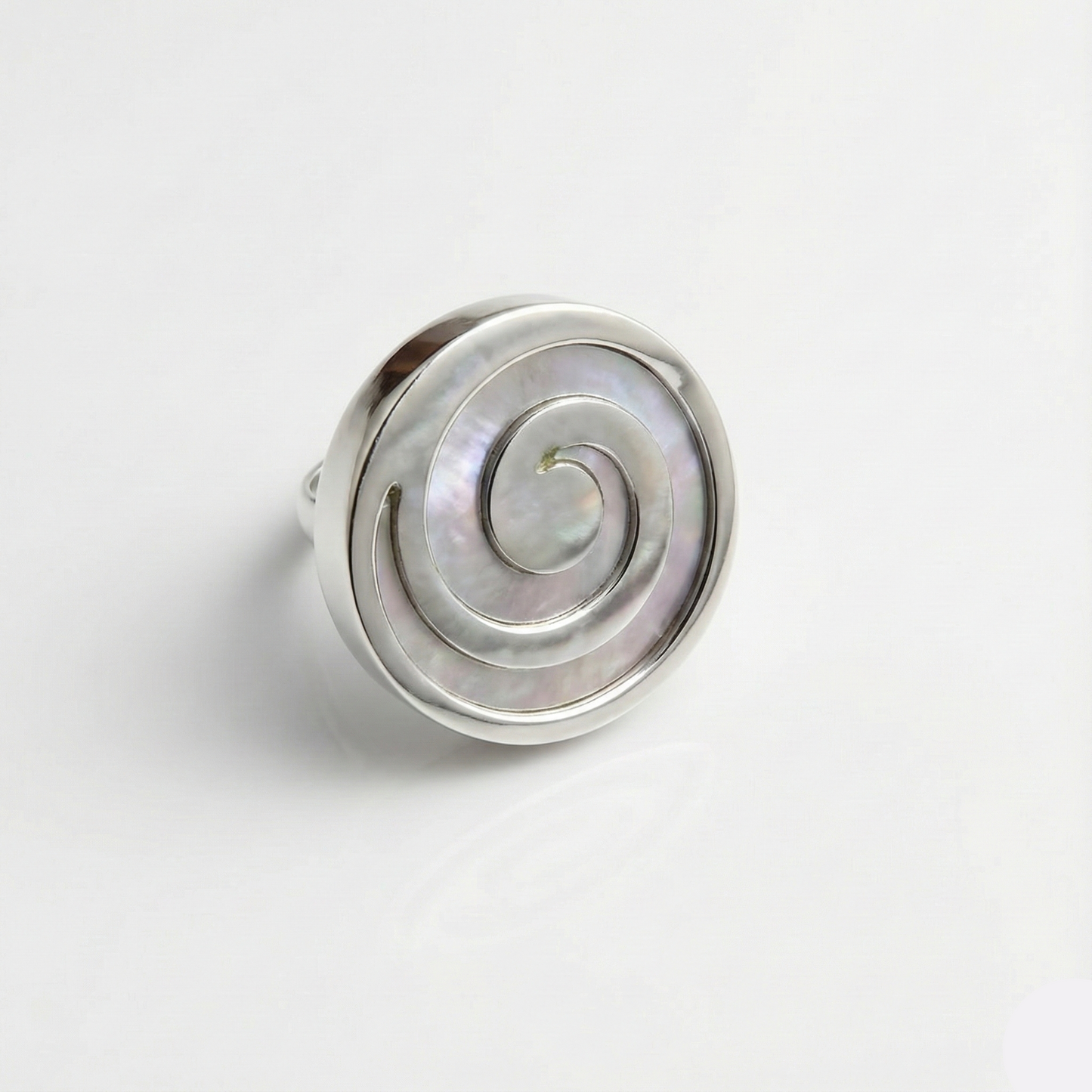Silver ring with a spiral design on a white background