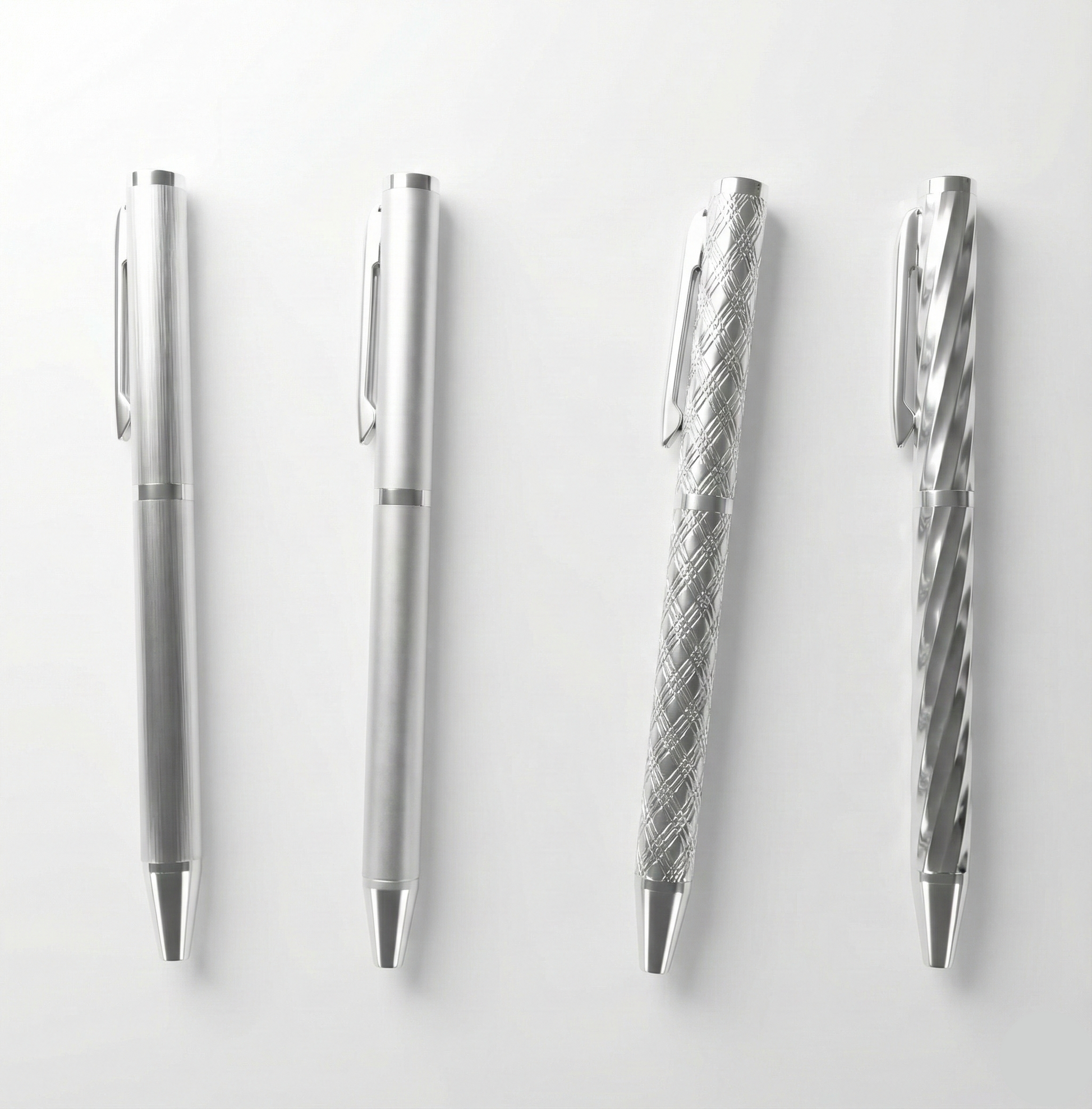 Set of silver pens with different designs on a white background