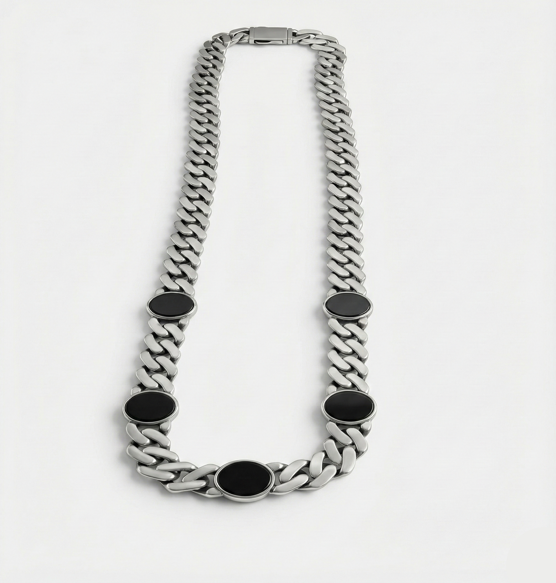 Silver chain necklace with black oval accents on a white background