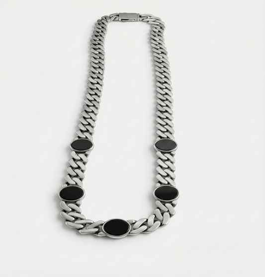 Silver chain necklace with black oval accents on a white background