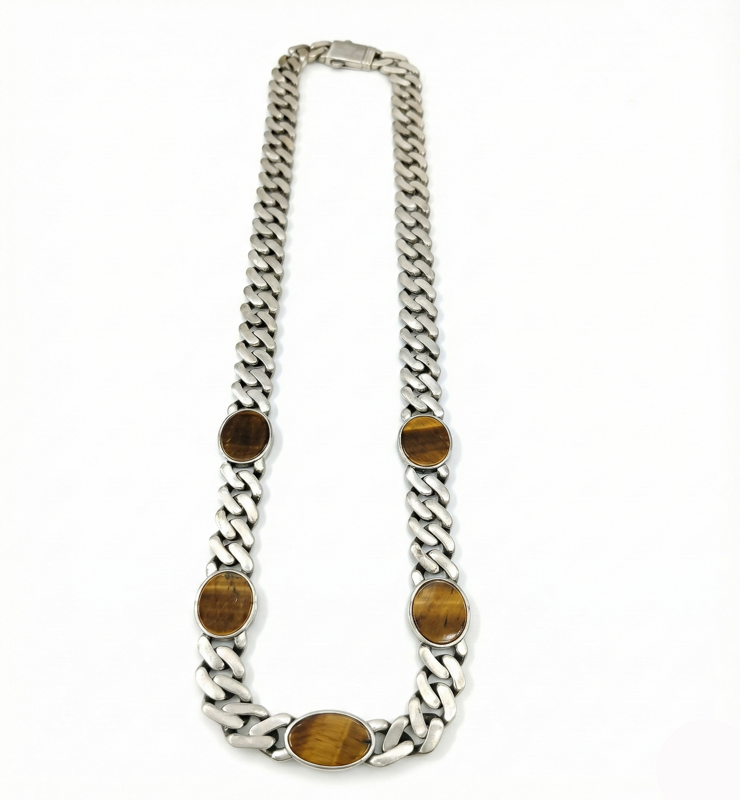 Silver chain necklace with brown oval stones on a white background