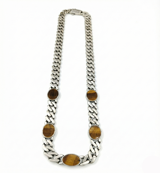 Silver chain necklace with brown oval stones on a white background