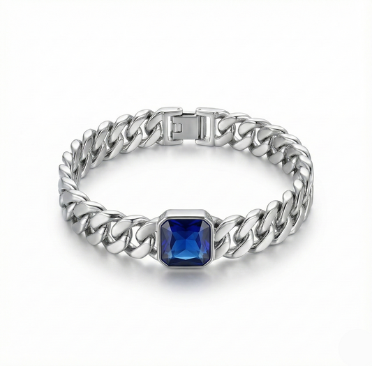 Silver chain bracelet with a blue gemstone on a white background
