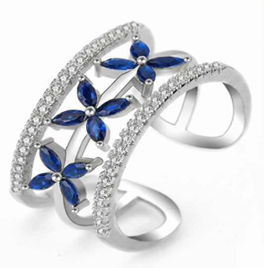 Silver ring with blue gemstones on a white background