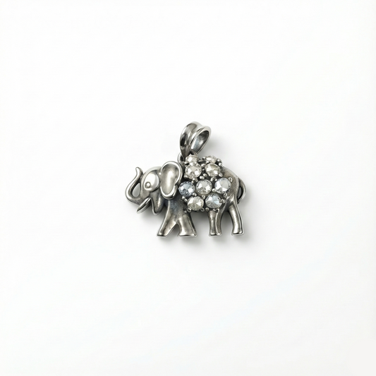 Silver elephant pendant with gemstones on a white background