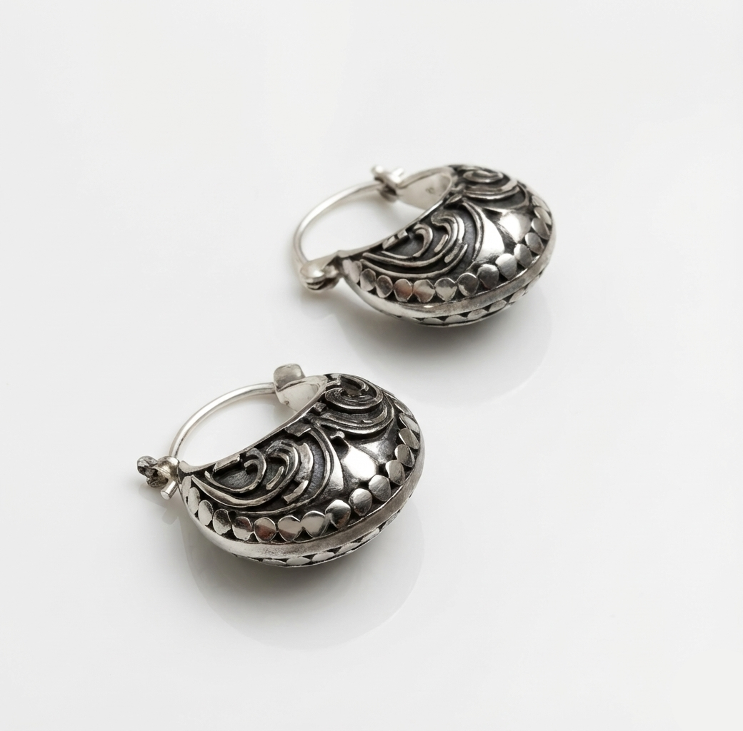 Pair of silver hoop earrings on a white background