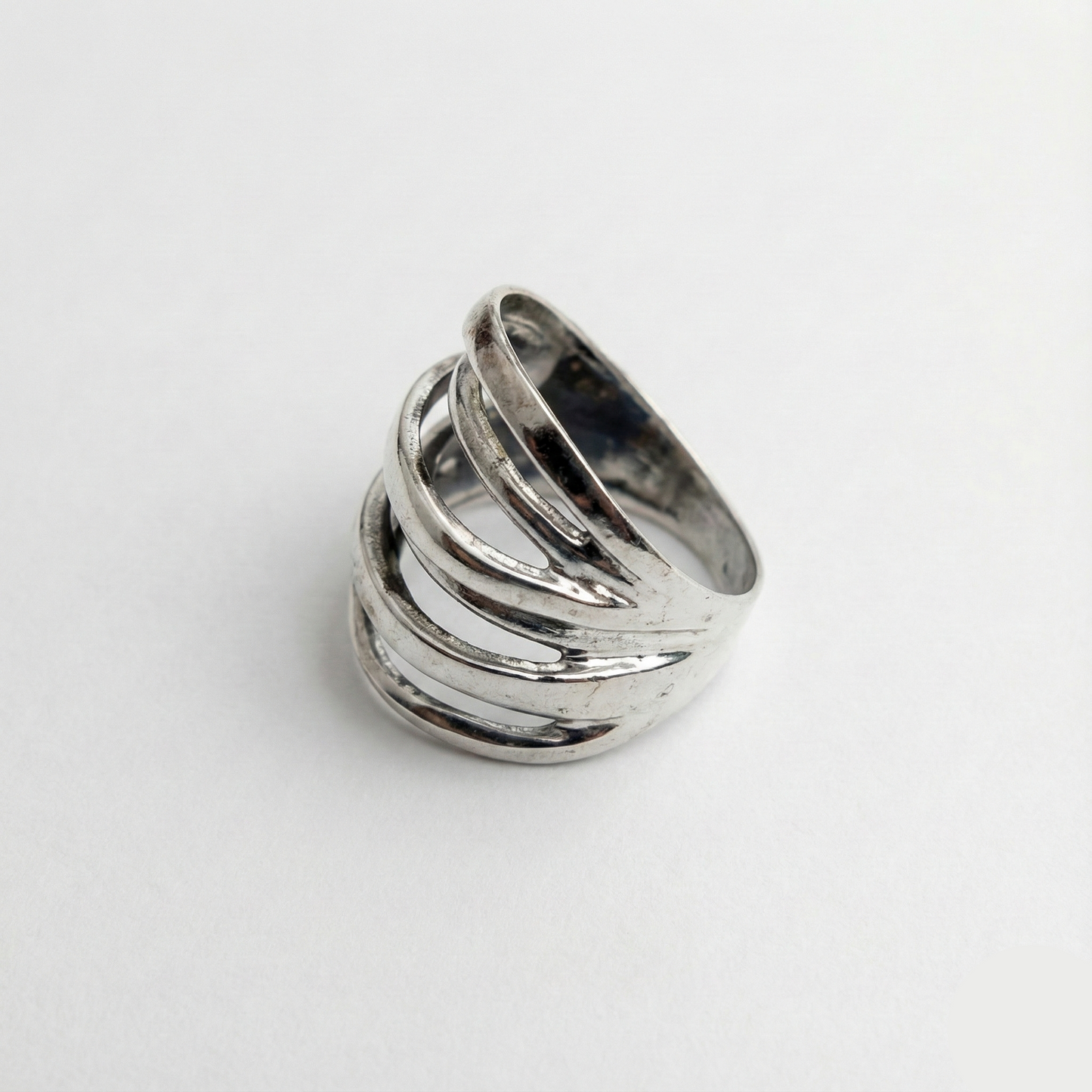 Silver ring with multiple bands on a white background