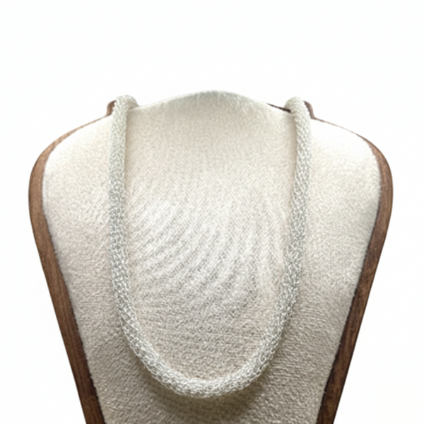 White knitted scarf on a mannequin with a white background