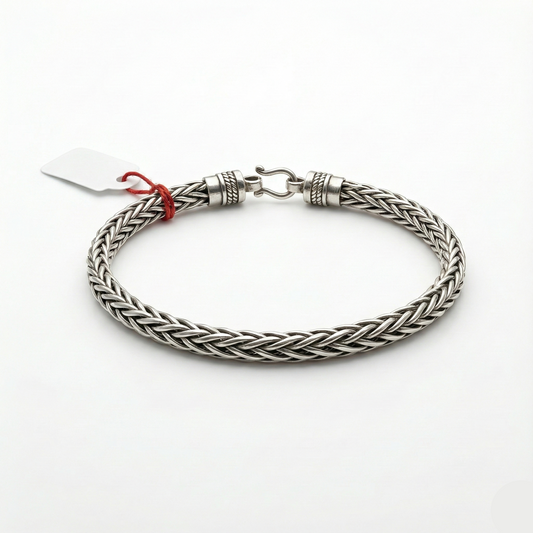 Silver braided bracelet on a white background