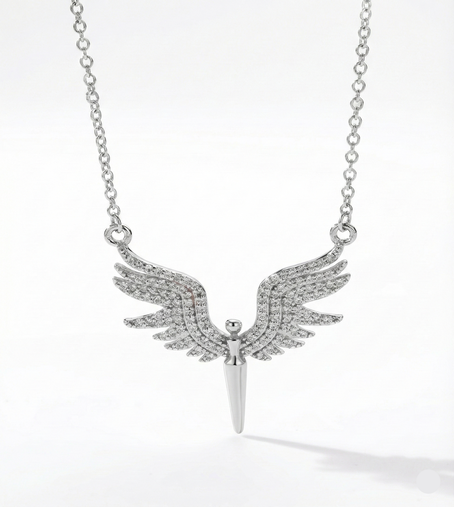 Silver necklace with winged pendant on a white background